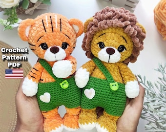 May include: Two handmade crochet stuffed animals: a tiger and a lion. The tiger is orange with black stripes, and the lion has a brown mane. Both wear green overalls. The text "Crochet Pattern PDF" and a US flag are in the image.