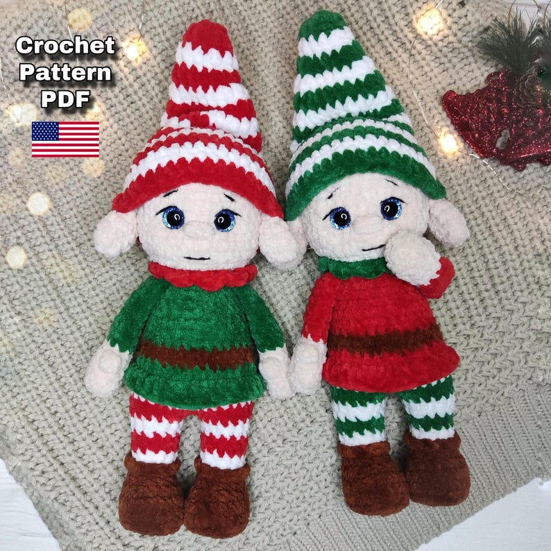 May include: Two handmade crochet elf dolls. One elf wears a green outfit with red and white striped hat and pants. The other elf wears a red outfit with a green and white striped hat and pants. The dolls have blue eyes and brown boots. The text "Crochet Pattern PDF" and a US flag are in the upper left corner.
