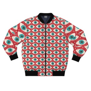 May include: A red bomber jacket with a repeating eye pattern in cream, teal, and black. The jacket has a black collar, cuffs, and hem, and a full-length zipper. The eye design features teal irises with star details.