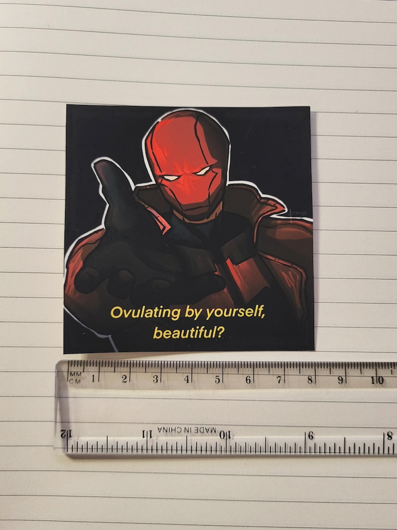 May include: Square sticker featuring a comic book style illustration of a character in a red helmet and costume, pointing. The text "Ovulating by yourself, beautiful?" is in yellow. The sticker is approximately 3 inches wide.