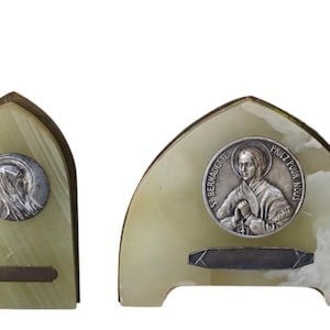 May include: A set of three ceramic mugs with a speckled, matte finish. The mugs are in shades of cream, light gray, and dark gray. Each mug has a simple, minimalist design and a rounded handle.