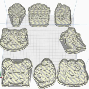 May include: A selection of 3D-printed cookie cutters in various shapes. Designs include a cat face, a bird, a soda pop, a noodle container, and three different girl faces. The cookie cutters are light beige in colour.