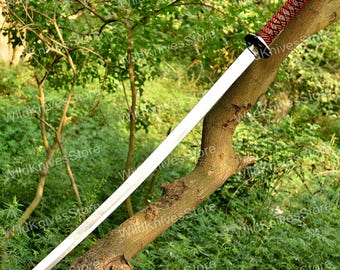 Handcrafted Katana with Red-Black Wrapped Handle Displayed Outdoors