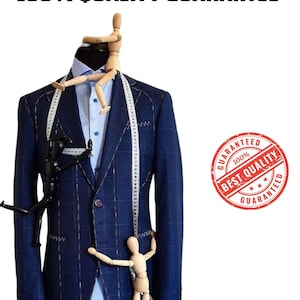 May include: A navy blue plaid suit jacket with a light blue dress shirt, white measuring tape, and wooden artist mannequins. The image includes the text "100% QUALITY GUARANTEE" and a red stamp that says "BEST QUALITY GUARANTEED".