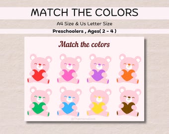 Op de afbeelding: Een printbaar educatief spel voor kleuters. De afbeelding bevat de tekst "Match the Colors" en "Match the colors". Het spel toont acht roze teddyberen, elk met een hart in een andere kleur: rood, roze, paars, oranje, groen, blauw, geel en bruin.