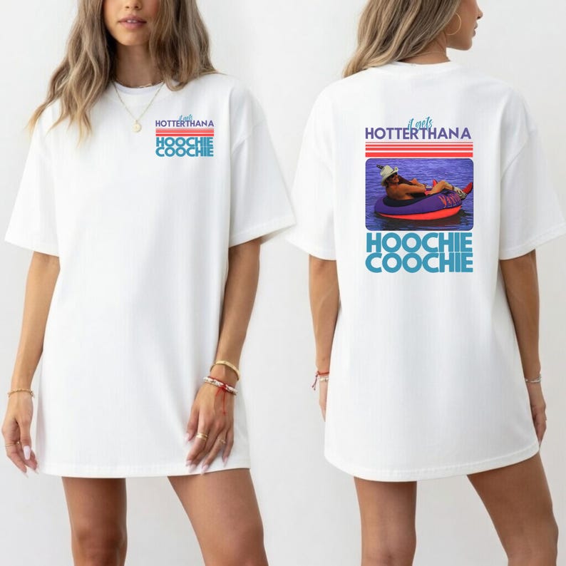 May include: White t-shirt with the text "It gets HOTTERthana HOOCHIE COOCHIE" in blue and red. The back of the shirt features a graphic of a person in a tube on the water with the same text.