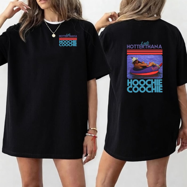 May include: Black t-shirt with the text "Hoochie Coochie" in blue and red. The front of the shirt has the text "Hotter Than A Hoochie Coochie". The back of the shirt has a graphic of a person in a tube.