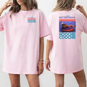 May include: Light pink t-shirt with the text "HOTTERTHANA HOOCHIE COOCHIE" on the front. The back of the shirt features a graphic of a person in a tube on the water, with the text "It gets HOTTERTHANA HOOCHIE COOCHIE".
