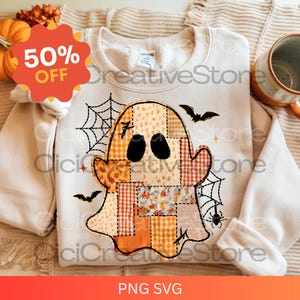 May include: A cream-coloured sweatshirt with a patchwork ghost design. The ghost has black eyes and a stitched outline, surrounded by a spiderweb, bats, and a spider. The image also includes a 50% off sticker and the text "PNG SVG".