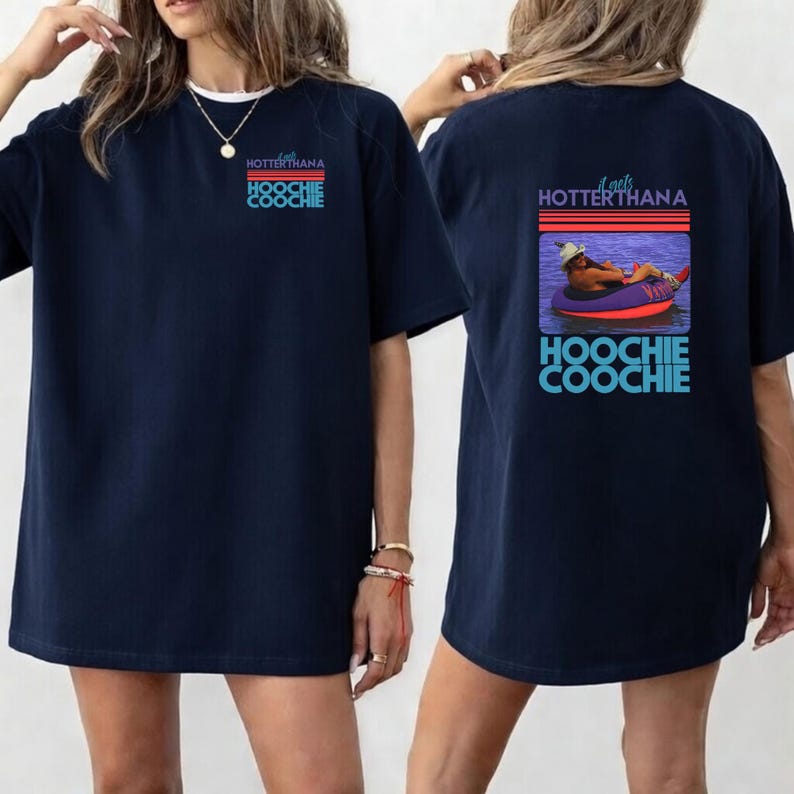 May include: Navy blue t-shirt with the text "HOTTERTHANA HOOCHIE COOCHIE" on the front and a graphic on the back of a person floating in a tube. The graphic includes the text "HOOCHIE COOCHIE".