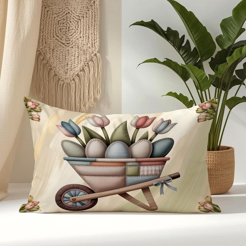 May include: A rectangular throw pillow featuring a central illustration of a wheelbarrow filled with pastel-colored eggs and tulips. The design uses a patchwork-style pattern in muted tones of blue, pink, and beige, accented by a small bow.