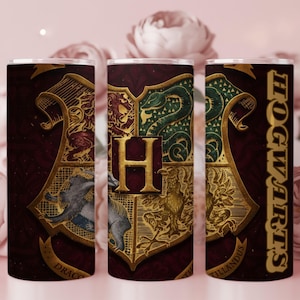 May include: A set of three stainless steel tumblers featuring the Hogwarts crest in gold and the word "Hogwarts" in gold lettering. The crest is set against a burgundy background. The tumblers are cylindrical and suitable for hot or cold beverages.