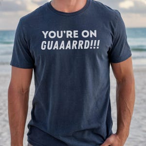 May include: A set of three ceramic mugs with a speckled, matte finish. The mugs are in shades of cream, light brown, and dark brown. Each mug has a simple, minimalist design and a rounded handle.