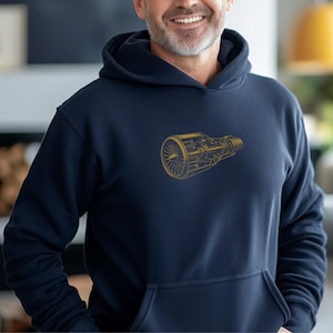 May include: Navy blue hoodie with a gold-colored illustration of a jet engine. The design is centered on the chest of the hooded sweatshirt. The hoodie has a front pocket and a drawstring hood.