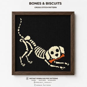 May include: A framed cross stitch pattern titled BONES & BISCUITS featuring a white skeleton of a dog playing in a bow position on a black background. The dog holds an orange bone in its mouth. The text includes INSTANT DOWNLOAD PDF PATTERNS.