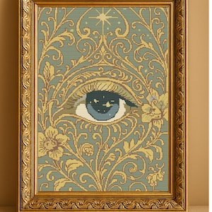 May include: Cross-stitch pattern titled "Celestial Gaze" featuring an eye with a starry iris, surrounded by floral and swirling patterns in gold and green. The artwork is framed in a gold ornate frame. Text includes "Digital Download - PDF Only".