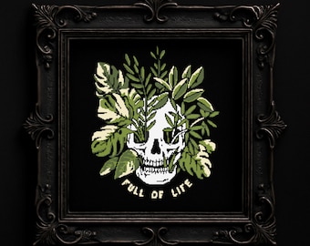 May include: Cross-stitch pattern featuring a skull with greenery, framed in a black ornate frame. The skull is white with green leaves and the text "FULL OF LIFE" in white. The words "DIGITAL PDF PATTERN" and "DMC COLORS" are at the top.