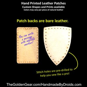 May include: Two leather patches, one rectangular and one shield-shaped, with pre-drilled holes for sewing. The rectangular patch has a message written on it: "You can write a message with indelible marker!"