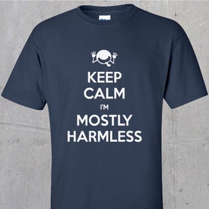 May include: A navy blue t-shirt with a white graphic of a cartoon character with the text "Keep Calm I'm Mostly Harmless".