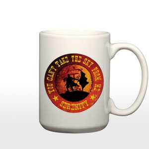 May include: White ceramic mug with a red, orange, and yellow circular design. The design features a silhouette of a person holding a flag with the text "You can't take the sky from me" and "Serenity" in a yellow font.