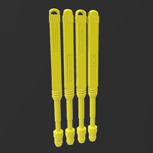 May include: Four yellow plastic tools with a textured surface and a loop at the top. The tools have a black design on the side.