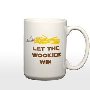 May include: White ceramic mug with a brown graphic of a yellow hand with wires and the text "Let the Wookiee win."
