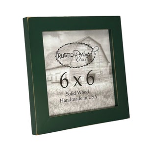 May include: A dark green wood picture frame with a distressed finish. The frame is 6x6 inches and says "Solid Wood Handmade in USA".