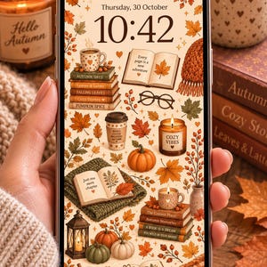Könnte beinhalten: Ein Smartphone-Bildschirm mit einem herbstlichen digitalen Hintergrundbild, das Illustrationen von Bücherstapeln, Kürbissen, Kaffeetassen, Kerzen, Brillen und verstreuten Herbstblättern auf cremefarbenem Grund zeigt, mit der Uhrzeit 10:42.