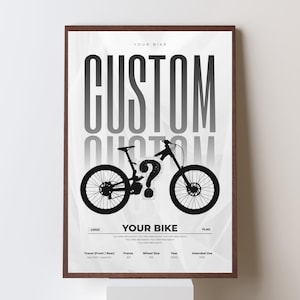 May include: A framed poster with a dark brown border features a black and white illustration of a mountain bike. The word "CUSTOM" is prominently displayed above the bike, with the text "YOUR BIKE" at the top and bottom. Additional fields for customization are included.