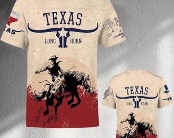 May include: A beige t-shirt with a map design and the word "TEXAS" above a longhorn graphic. A cowboy riding a horse is depicted in red and black. The back of the shirt also displays the "TEXAS" and longhorn design.