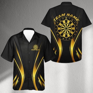 May include: Black button-down shirt with a gold dartboard design. The front of the shirt has the text "YOUR NAME" below a dartboard graphic. The back of the shirt has the text "TEAM NAME" above a dartboard graphic.
