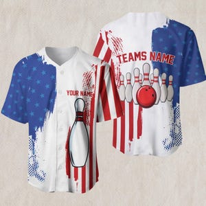 May include: White baseball jersey with a bowling theme. The design incorporates red and white stripes, blue stars, and a bowling pin graphic. The text "YOUR NAME" and "TEAMS NAME" are visible.