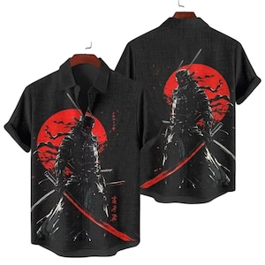 May include: Black button-up shirt featuring a graphic of a samurai warrior with a red sun backdrop. The design includes a samurai with two swords. The shirt is displayed on a wooden hanger.
