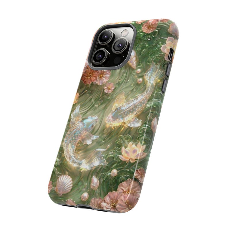 Angled product view of a green floral koi fish phone case on white, showing the square camera opening, black edge and printed back.
