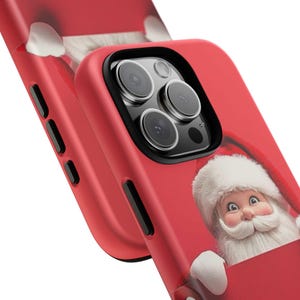 May include: Red phone case featuring a Santa Claus graphic. The case has a black camera lens protector and a smooth finish. The Santa Claus illustration includes a white beard and hat, with a smiling face. The case is designed for a smartphone.
