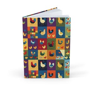 May include: A colourful journal with a patchwork design featuring various chickens in different colours. The journal is open, revealing blank white pages. The cover has a vibrant, eye-catching pattern.