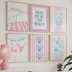 May include: Six framed art prints with beach-themed illustrations in pink and blue. The prints include text that says "golden hour girl" and "Meet me at the beach", along with images of a lobster, seashells, and a bikini.