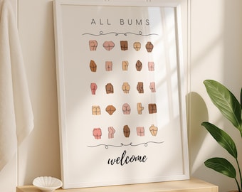 May include: A framed print with the words "ALL BUMS welcome" and illustrations of various buttocks. The print is displayed above a wooden shelf with rolled towels, a small white dish, and a potted plant.