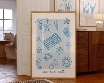 May include: A framed print with a light blue beach-themed illustration. The artwork includes a bikini, ice cream cone, starfish, grapes, crab, flip-flops, and a beach towel. The words "sea sun salt" are at the bottom.