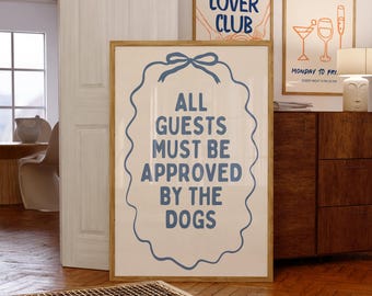 May include: A framed print with the text "ALL GUESTS MUST BE APPROVED BY THE DOGS" in blue. Two other framed prints are visible, one with "PASTA LOVER CLUB" and another with "HAPPY HOUR". The prints are displayed in a room with wooden floors.