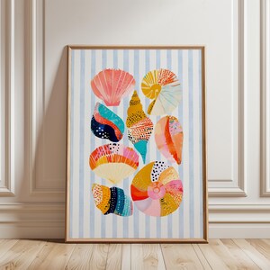 May include: A framed vertical wall art print featuring a collection of colorful seashells arranged on a light blue and white vertical striped background. The shells display various patterns, including polka dots and stripes in shades of pink, orange, yellow, blue, and teal.