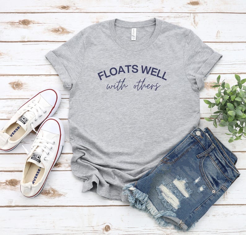 Cute lake day tee paired with cutoffs and sneakers, perfect summer uniform for chill float vibes.