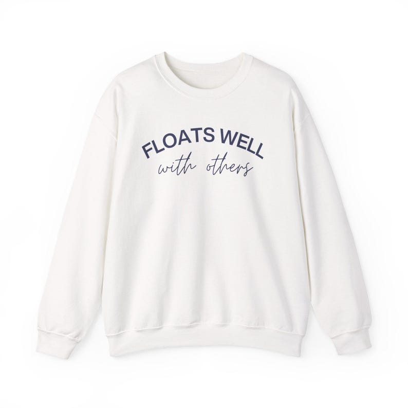 Cozy fleece crewneck with navy script print, styled for warm weather layering, float brunch, or lake house lounging.