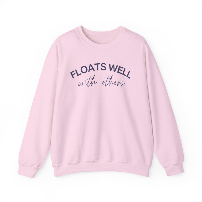 Light pink cozy float sweatshirt with playful message, perfect for matching lake day looks and relaxing boat rides.