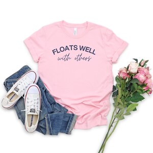 Light pink cozy float sweatshirt with playful message, perfect for matching lake day looks and relaxing boat rides.