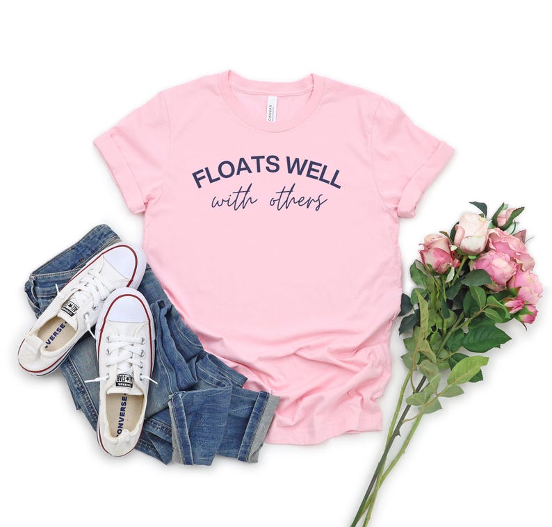 Light pink cozy float sweatshirt with playful message, perfect for matching lake day looks and relaxing boat rides.