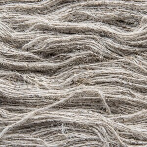 Texture detail of natural nettle yarn fibers sourced from the Himalayan foothills.