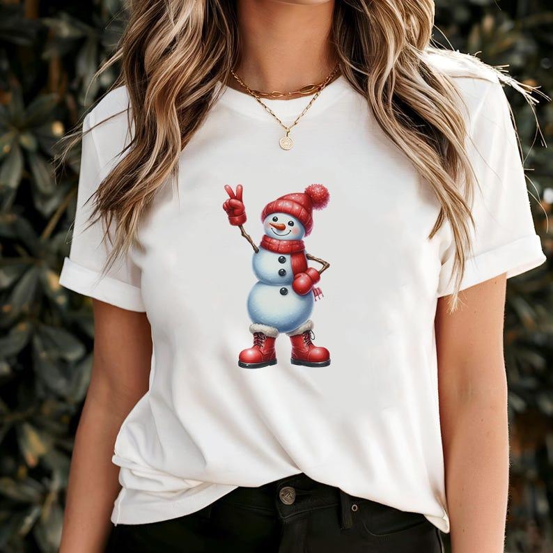 Pu&ograve; includere: T-shirt bianca con grafica di pupazzo di neve. Il pupazzo di neve indossa cappello, sciarpa e stivali rossi e fa il segno della pace. Il design ha un tema festivo delle vacanze invernali.