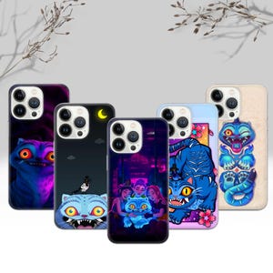 May include: A collection of phone cases featuring cartoon cat designs in various styles. The cases showcase vibrant colors, including blue, purple, and pink, with detailed illustrations of cats with expressive eyes and unique backgrounds. The cases are designed for a smartphone.