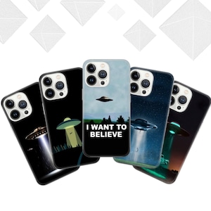 May include: Five smartphone cases with alien-themed designs. The cases display UFOs, light beams, and the text "I WANT TO BELIEVE" on a blue backdrop. The cases have a glossy finish and are designed for a smartphone.